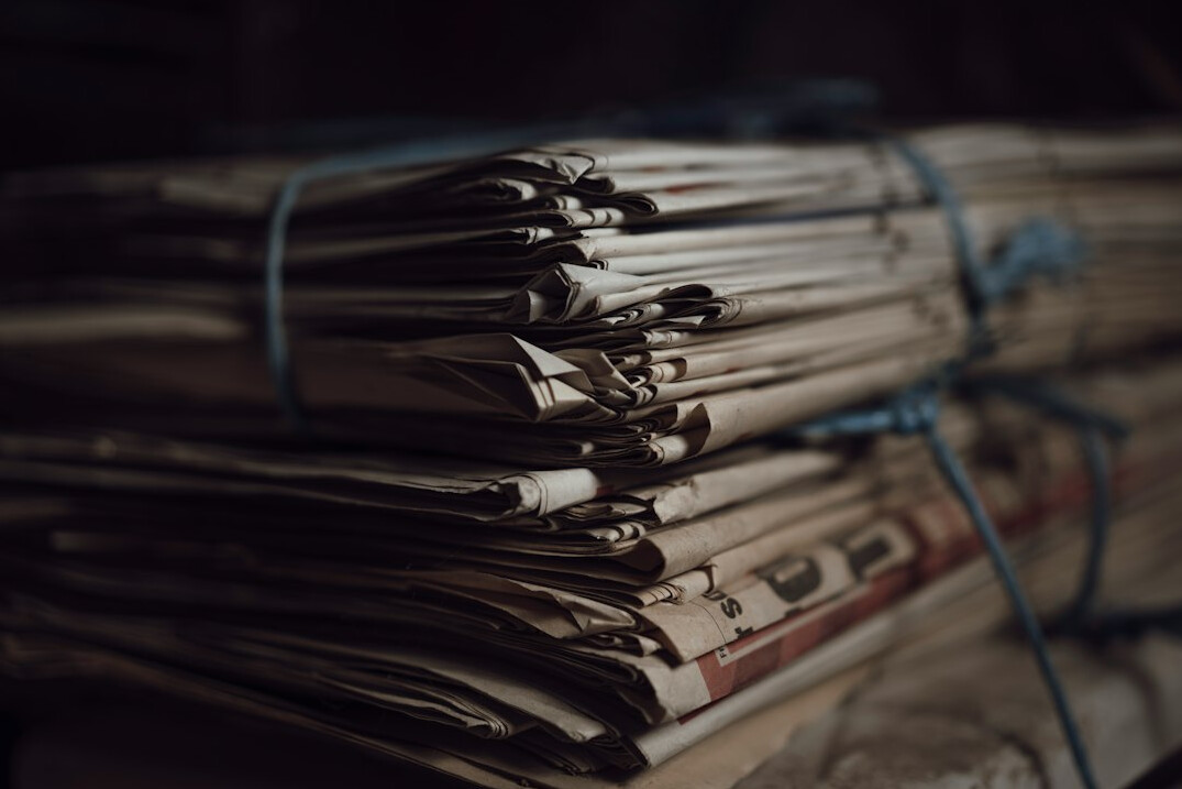 newspaper stack on desk