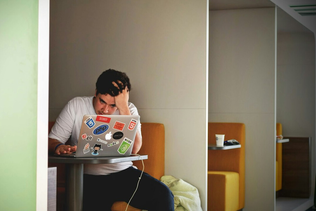 person thinking with laptop